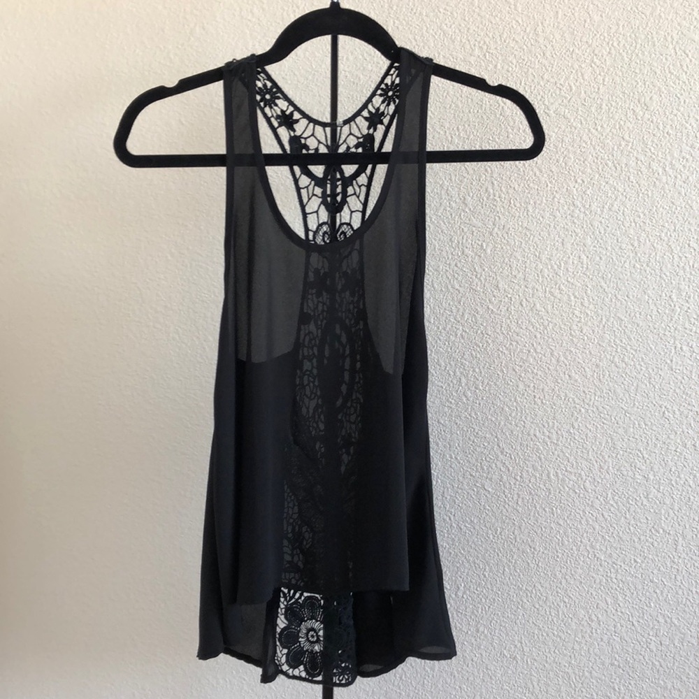 A black sheer sleeveless top with flowered details